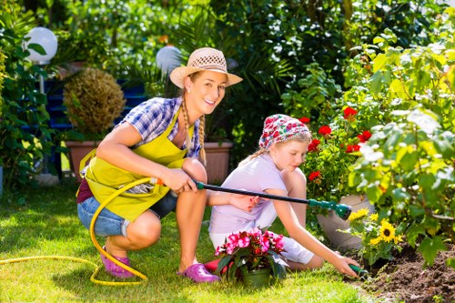 Lawn mowing crew trimming a residential lawn in Swiss Cottage