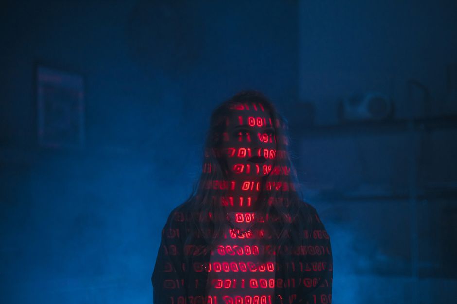 A close-up view of a computer screen displaying lines of HTML code in a dark-themed editor window. The code includes tags such as <div>, <span>, and <a>, with various class and aria-label attributes v